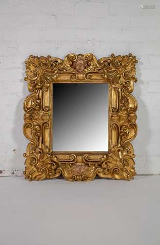 A fine and deeply carved giltwood and gesso wall mirror,Ital...