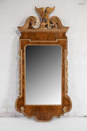 A fine and rare George II parcel-gilt and walnut wall mirror...