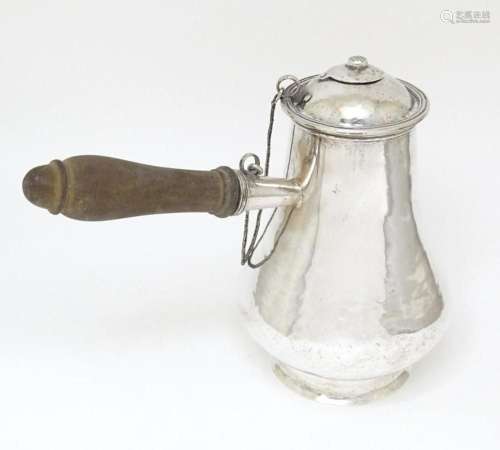 A 19thC white metal chocolate pot of bellied form with hamme...