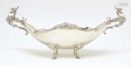 A 925 silver dish of boat form with twin handles formed as s...