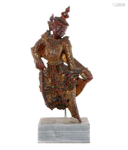 A very decorative Thai jewelled red gesso figure of a deity,...