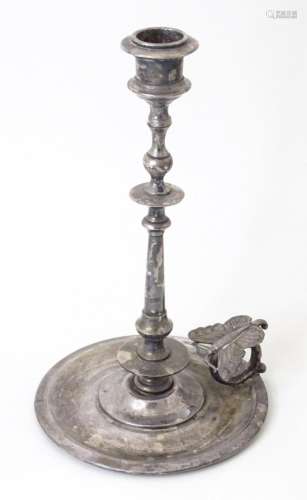 A Continental white metal candlestick of chamberstick form w...