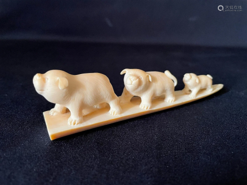 A Carved Cattle Bone Netsuke of 3 Piglet Dogs