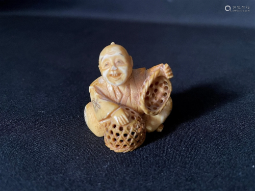 A Carved Cattle Bone Netsuke of Man with Basket