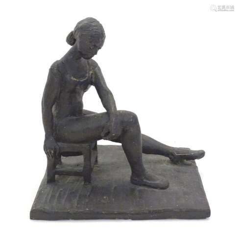 A 20thC clay sculpture modelled as a seated ballerina. Singe...