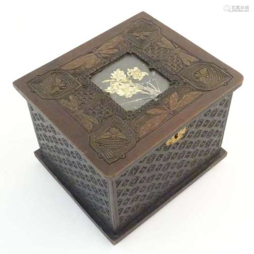An Art Nouveau wooden box with carved decoration depicting d...