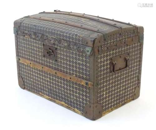 An early 20thC child s wood bound travelling trunk with dome...