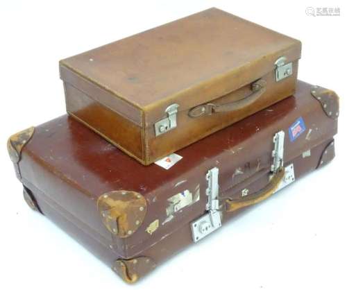 A mid 20thC  Revelation  suitcase, with affixed transit labe...
