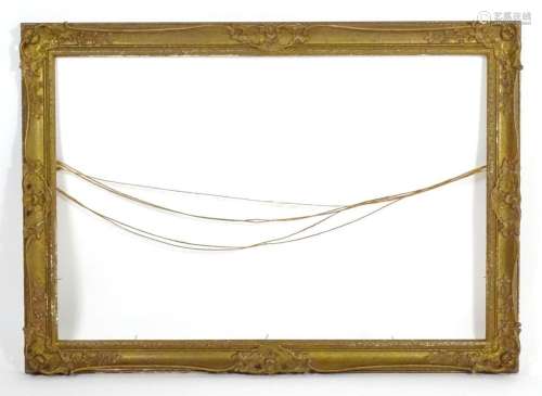 An early 20th century gilt and gesso swept frame with floral...