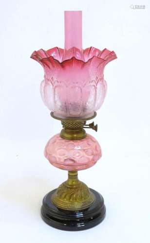 A Victorian Veritas table oil lamp, the circular stepped cer...
