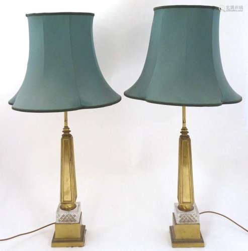 A pair of mid 20thC brass table lamps, the squared stepped b...