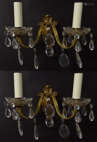A pair of 20thC gilt twin branch wall lights, the gilt mount...