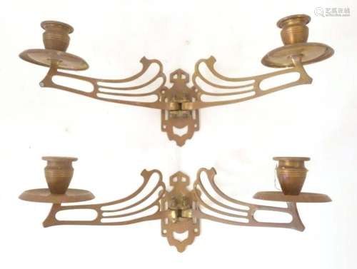A pair of Art Nouveau brass twin branch piano candle sconces...