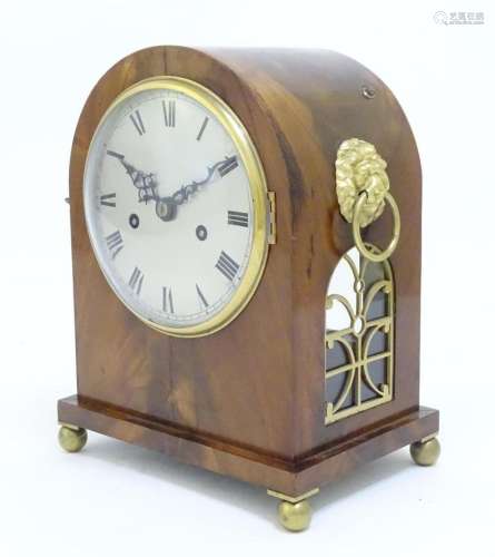 A mahogany bracket clock, the arched case with twin lions pa...