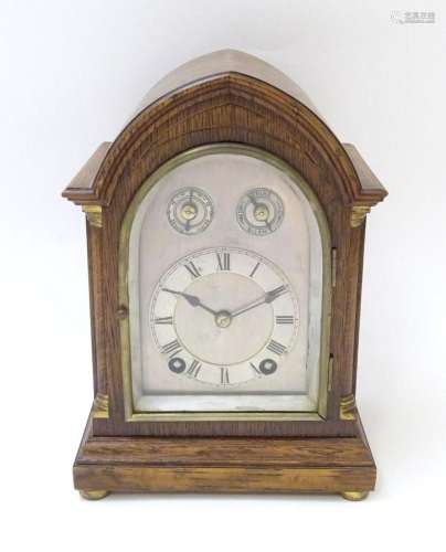 Edwardian oak cased lancet mantel clock, the silvered dial w...