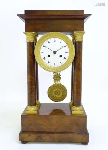 A French Empire style Portico clock with four columns, gilt ...