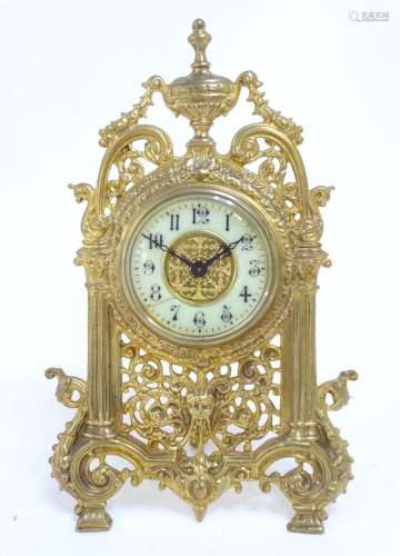 A gilt metal strut clock / timepiece. The Arabic dial set wi...