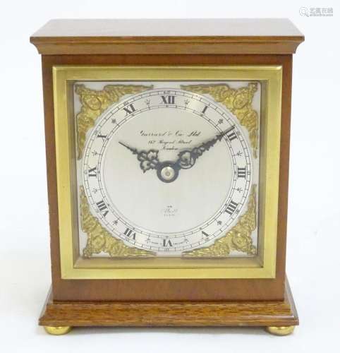 A mahogany cased mantle clock, the dial signed Garrard &...