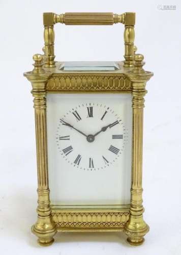 A brass carriage clock with white enamel dial. the whole 6 1...