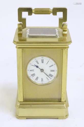 A brass carriage clock striking on a gong and with Anglaise ...