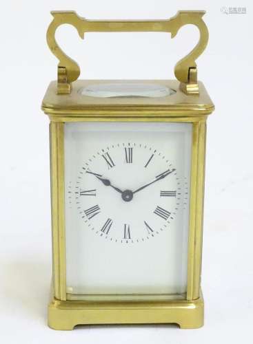 A brass carriage clock with white enamel dial. the whole 5 3...
