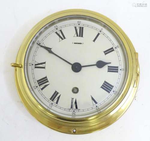 An 20thC brass cased ships bulkhead clock. The dial approx 5...