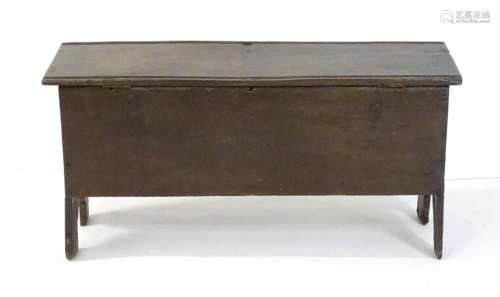 A mid 17thC oak six-plank sword chest. having a chamfered fr...