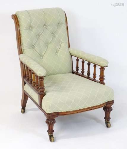 A mid / late 19thC mahogany armchair with a scrolled deep bu...