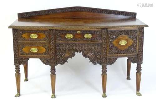 A late 19thC Anglo-Indian sideboard with a profusely detaile...