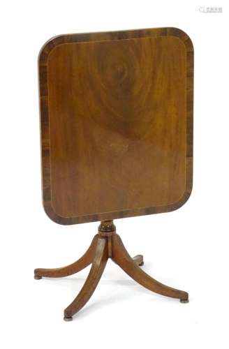An early 19thC mahogany table with an oblong table top havin...