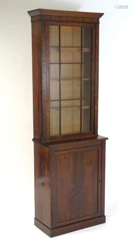 A mid 19thC rosewood bookcase with a moulded cornice above a...