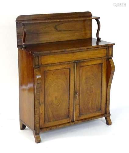 A Regency rosewood chiffonier with an upstand and shelf supp...