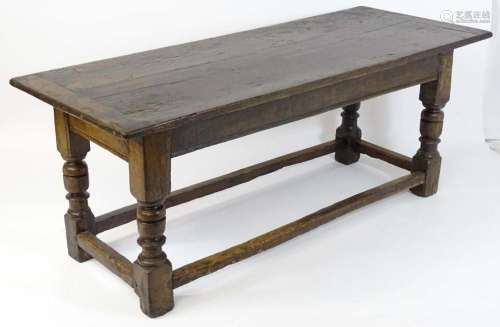 A mid 17thC joined oak refectory table with a three plank to...