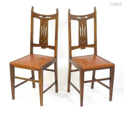 A pair of oak Art Nouveau hall chairs with bowed pierced top...