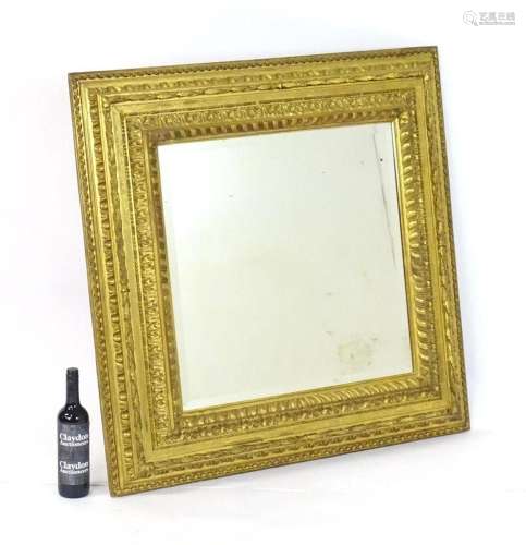 An early 20thC mirror with a giltwood and gesso surround. Be...