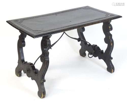 A 19thC Spanish ebonised table with a gadrooned edge and car...