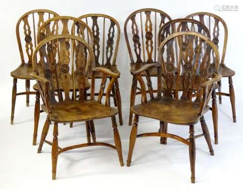 A set of eight C.1800 yew and elm Windsor chairs, having hoo...