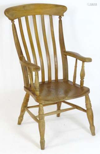 A late 19thC elm lathe back chair with a shaped top rail abo...