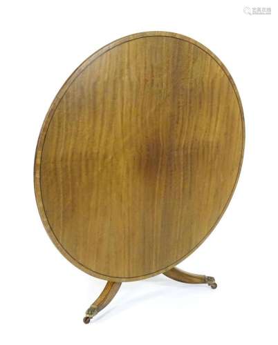 A Regency mahogany breakfast table with a circular top decor...