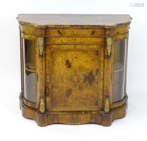 A 19thC burr walnut cabinet with a castellated top above a m...
