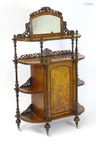 A 19thC walnut etagere / whatnot with a mirrored upstand abo...