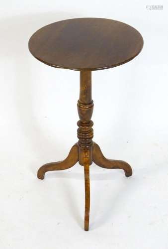 An early 19thC tripod table with a circular top above a pede...