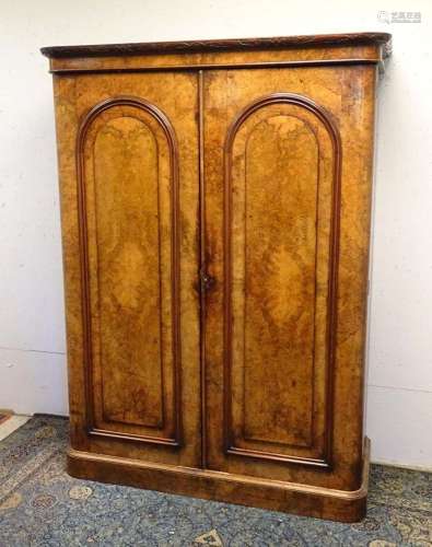 A mid / late 19thC walnut wardrobe with a carved cornice abo...
