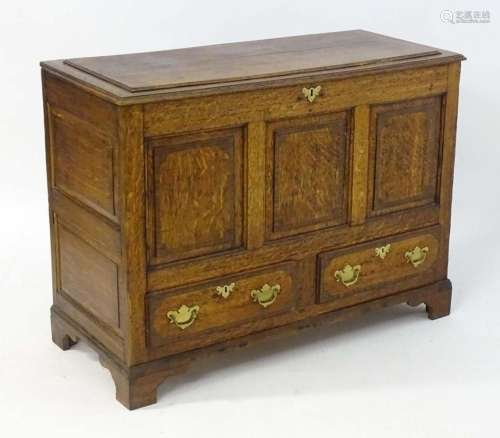 An 18thC and later oak mule chest with a moulded lid above t...