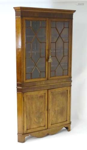 An early 19thC mahogany corner cupboard, having a moulded co...