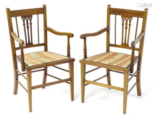 A pair of early 20thC mahogany elbow chairs with satinwood c...