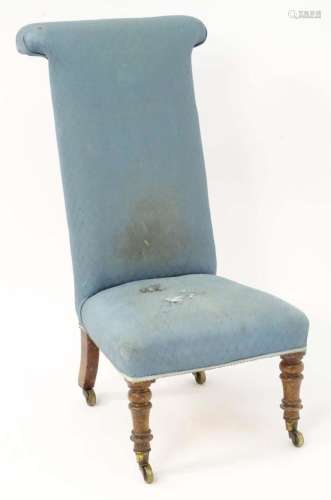 A mid 19thC prie dieu chair standing on turned tapering fron...