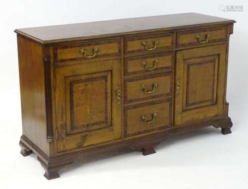 A George III style oak sideboard with a moulded top above si...