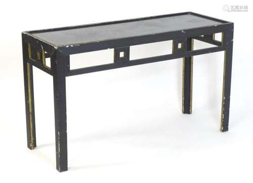 A mid 20thC French Art Deco table with an ebonised and gilt ...