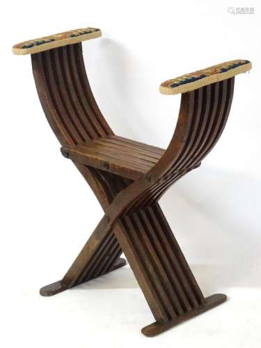 A 19thC folding mahogany Savonarola chair with upholstered a...